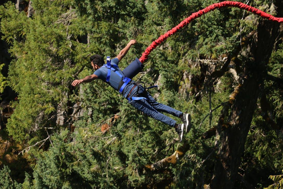 A person experiencing the thrill of bungee jumping, capturing the essence of adventure and excitement.