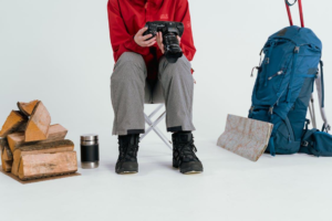 A man carrying a backpack, standing next to a tree, ready for an outdoor adventure in Atlanta.