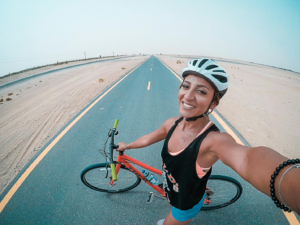 A solo traveler bikes on the road.