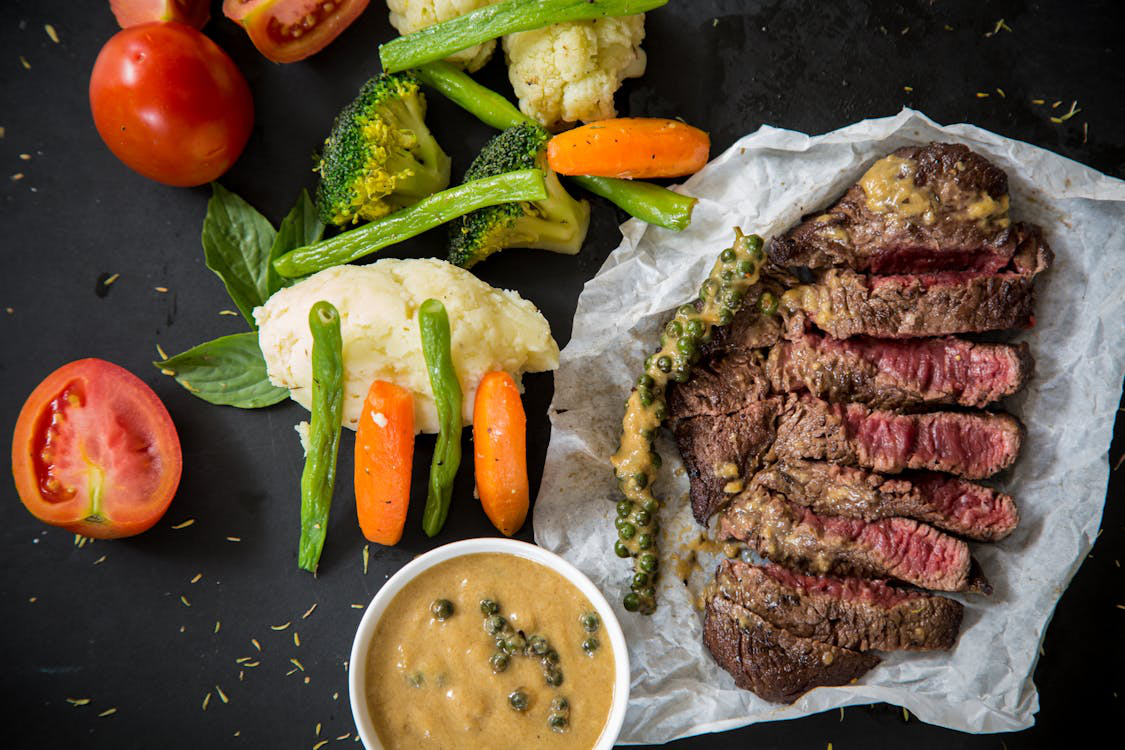 a steak and vegetables.