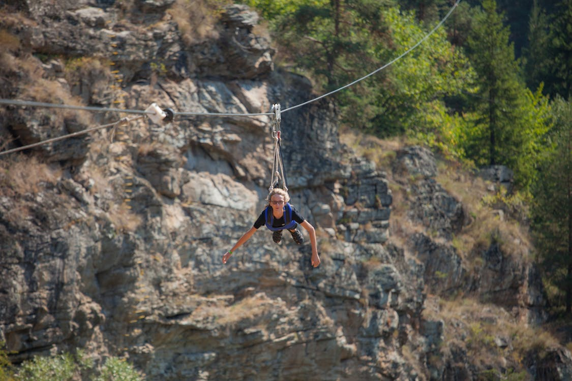 Person ziplining over rocky canyons